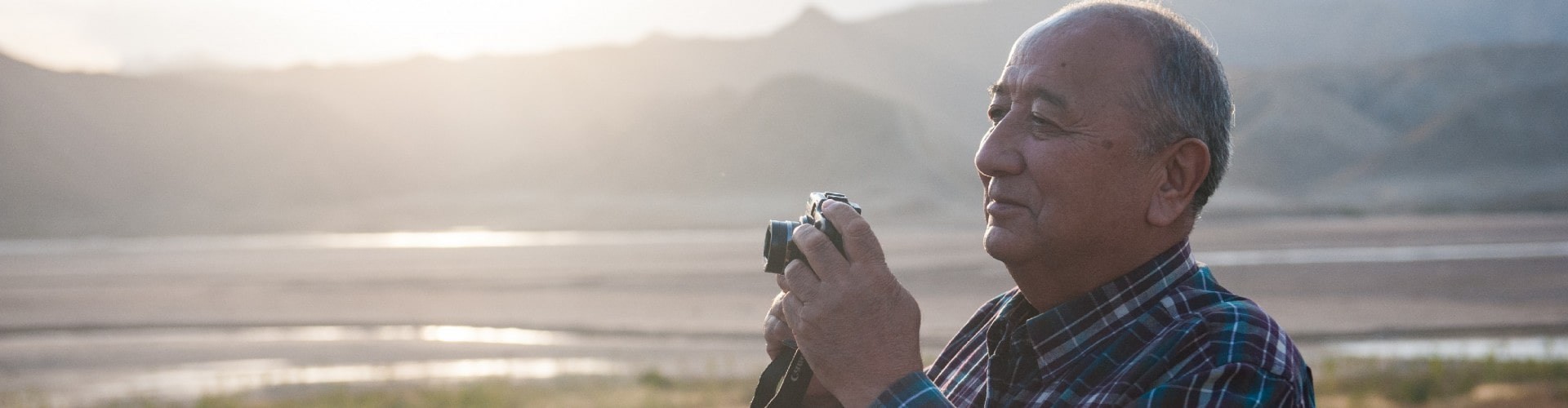 senior man taking a photo of the beautiful outdoors